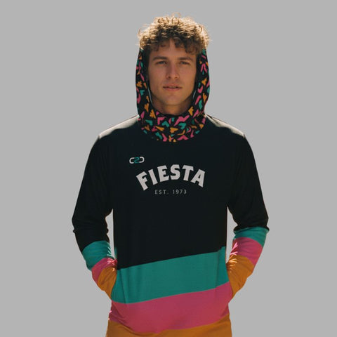 Person wearing a colorful hoodie with 'FIESTA' C2C Sports branding on a gray background